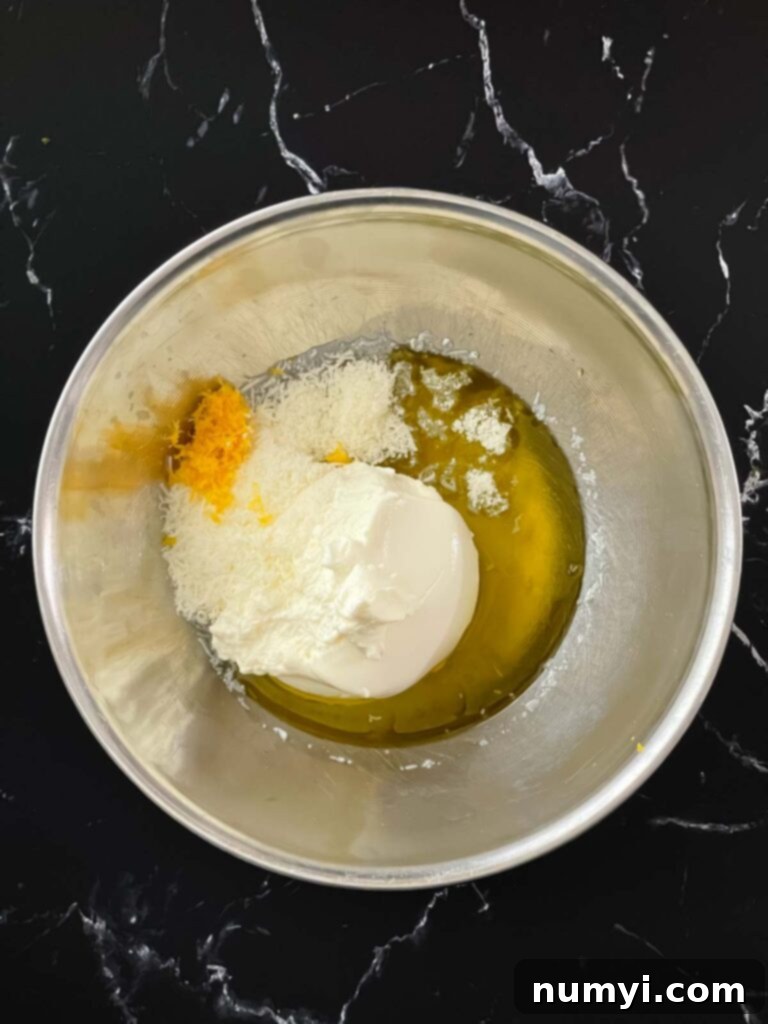 Lemon ricotta sauce ingredients in a stainless steel bowl.