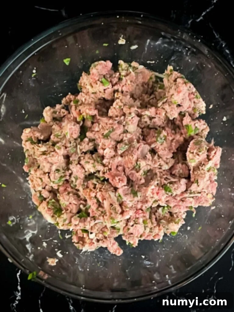 A ground beef mixture in a glass bowl.