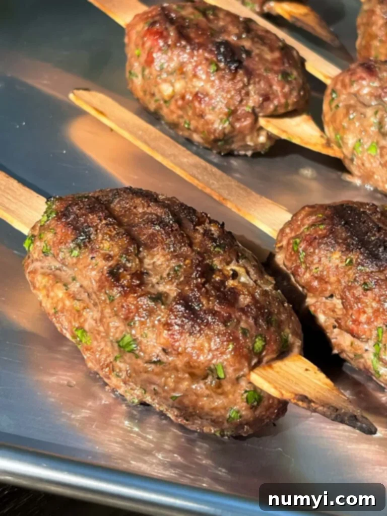 Grilled kofte on a baking pan.