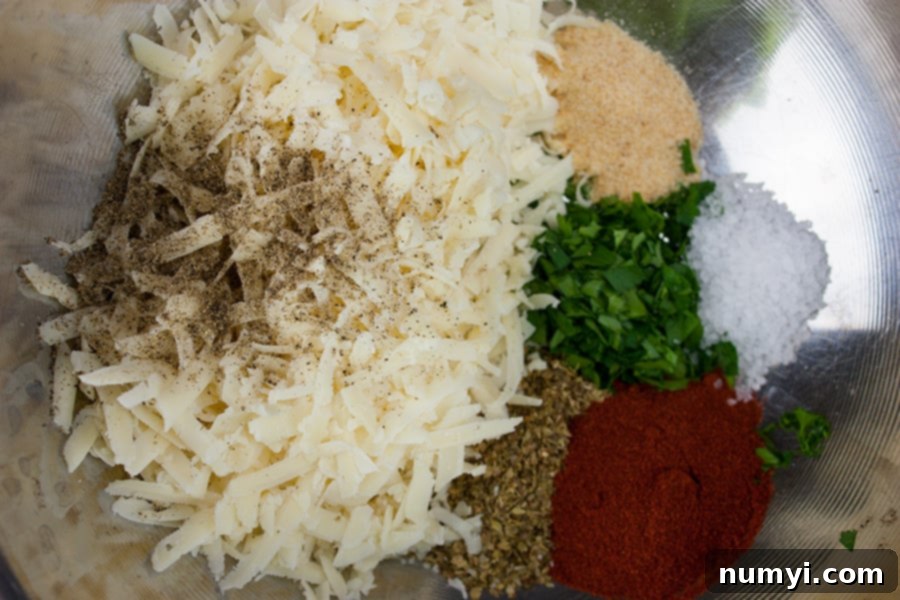 Parmesan cheese and spices in a metal bowl.