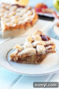 A slice of Caramel Apple Pie next to the whole pie.