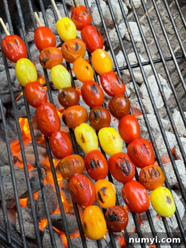 Fresh Grilled Shrimp and Corn Salad 11 Grape tomatoes blistering on a hot grill, showing the charring process.