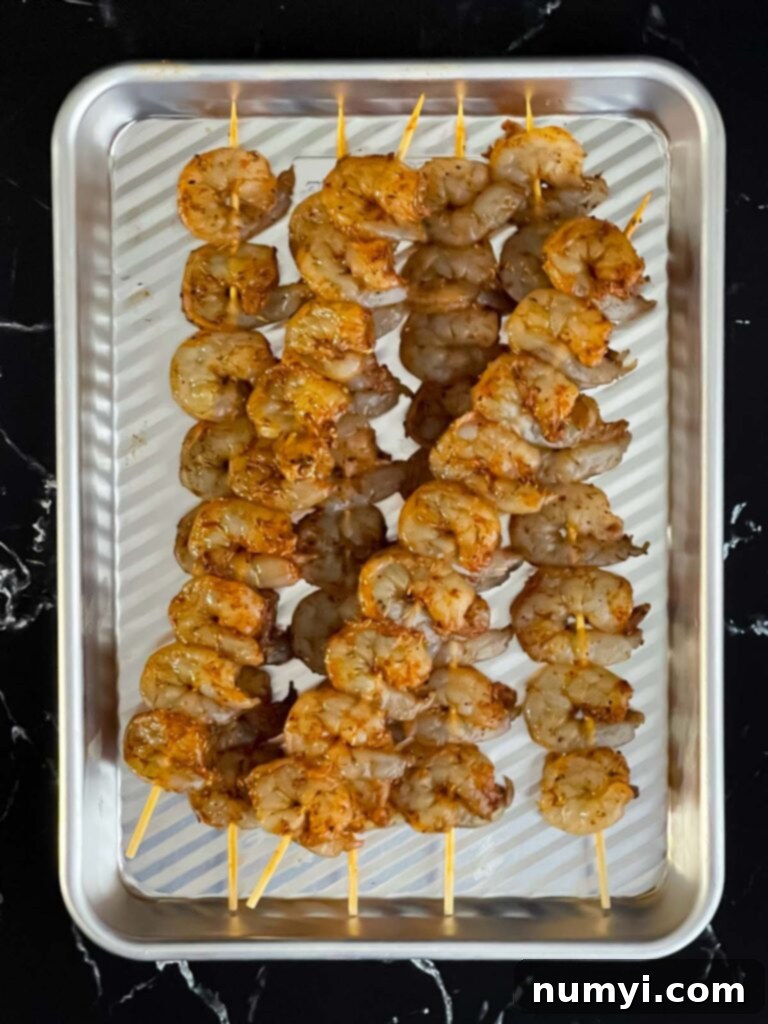 Fresh Grilled Shrimp and Corn Salad 12 Raw shrimp on skewers, showing even seasoning before grilling.