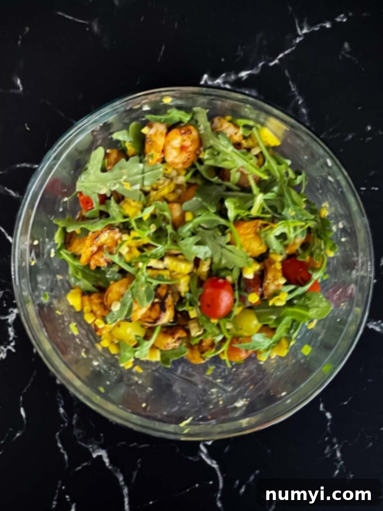 Fresh Grilled Shrimp and Corn Salad 15 Freshly assembled Grilled Shrimp and Corn Salad in a clear glass bowl, showcasing layers.