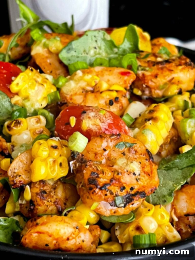 Fresh Grilled Shrimp and Corn Salad 17 Overhead shot of a dark bowl filled with fresh Grilled Shrimp and Corn Salad.
