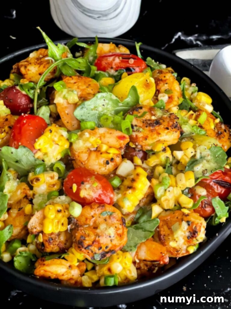 Fresh Grilled Shrimp and Corn Salad 3 Close-up of a delightful Grilled Shrimp and Corn Salad in a dark bowl, showcasing textures.