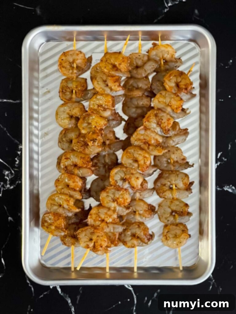 Fresh Grilled Shrimp and Corn Salad 7 Seasoned raw shrimp meticulously arranged on wooden skewers.