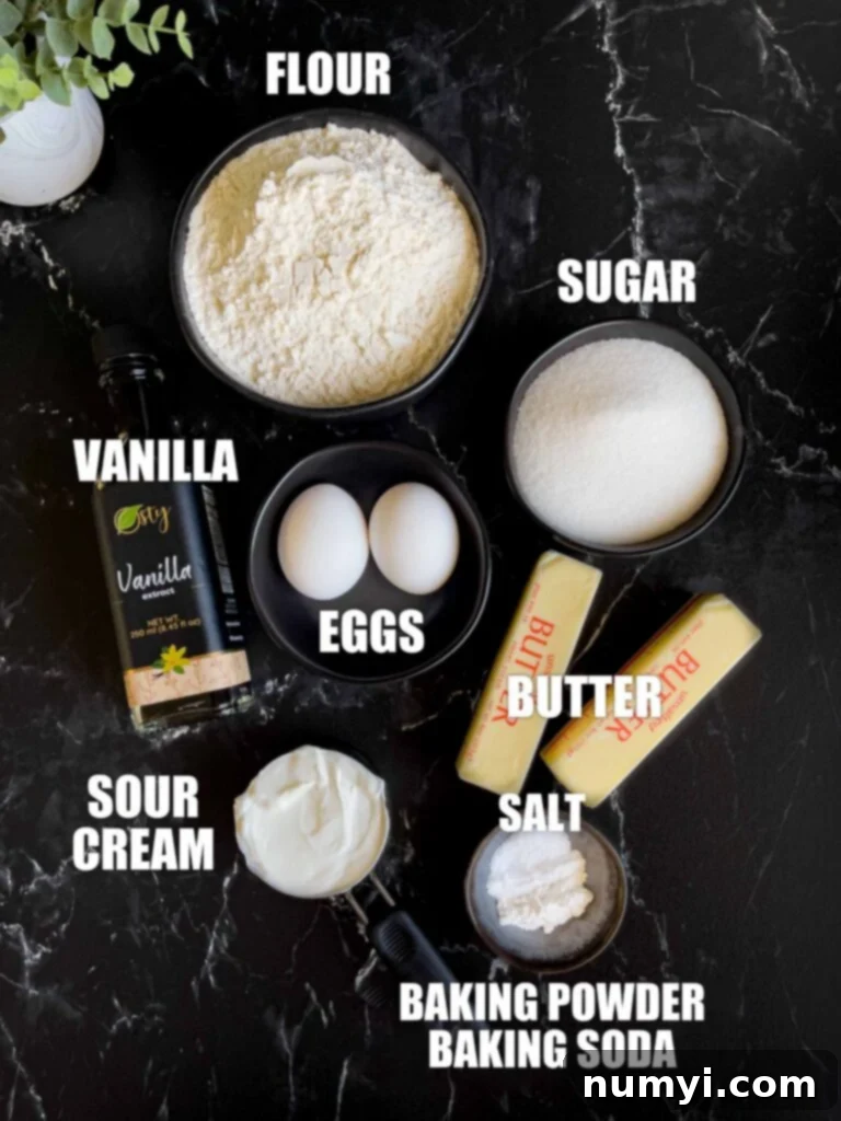 Soft frosted sugar cookie ingredients on a dark surface.