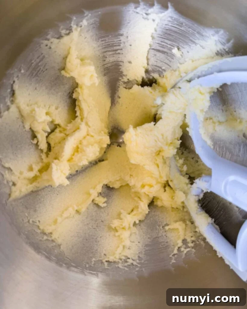 Butter and sugar creamed in a metal mixing bowl.