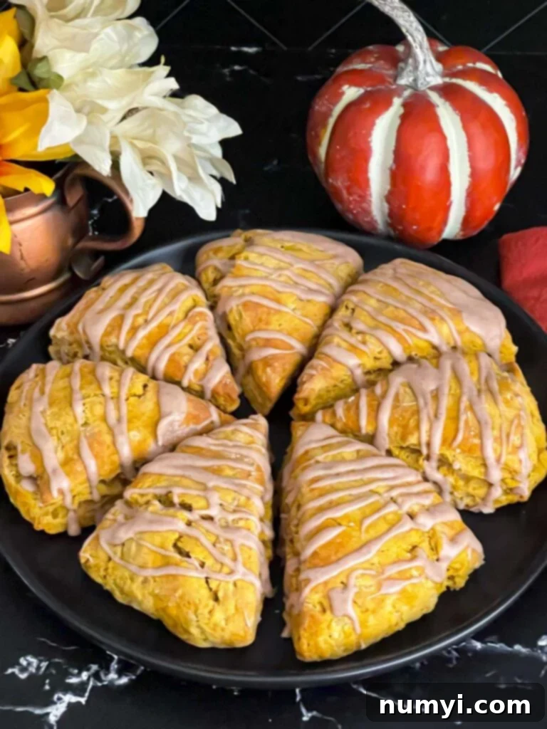 Pumpkin scones a dark plate on a dark surface.