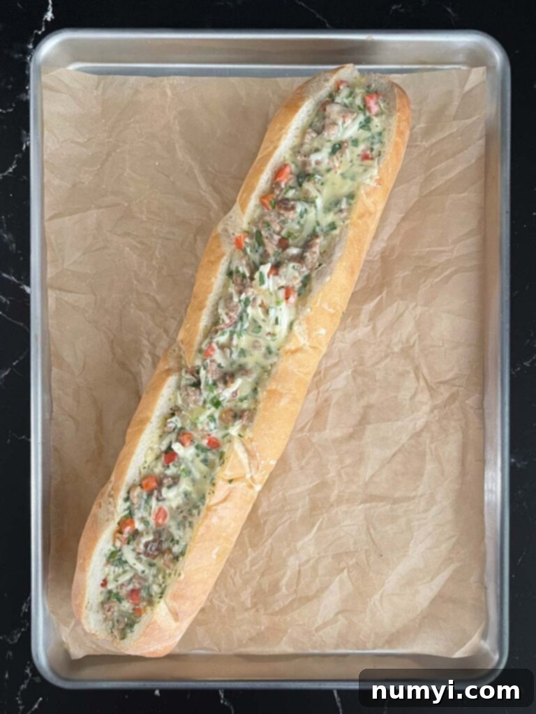 Loaded Sausage and Egg Baguette 12 Egg mixture being added to a hollowed out French bread loaf.