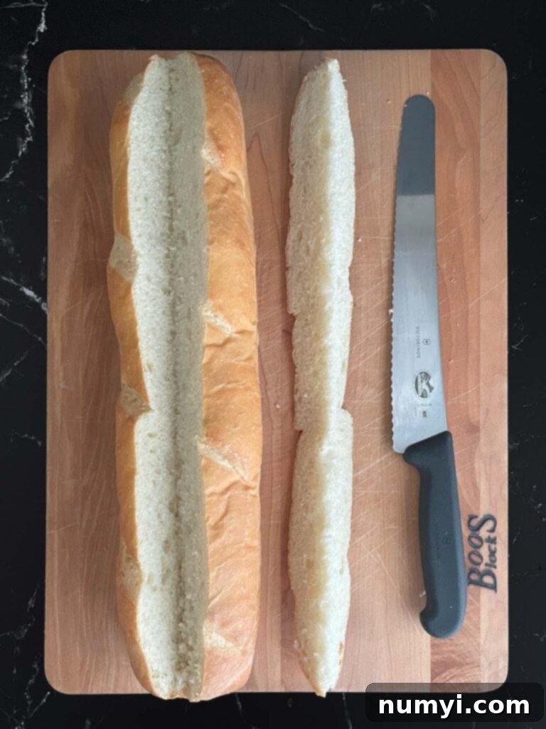 Loaded Sausage and Egg Baguette 10 French bread loaf with a V-shaped cut on top, showing the start of hollowing out.
