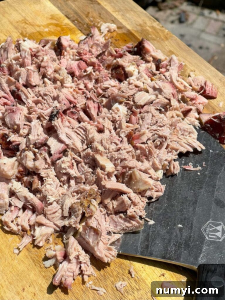 Smoky Pork Nacho Mountain 5 Chopped pork butt on a cutting board.