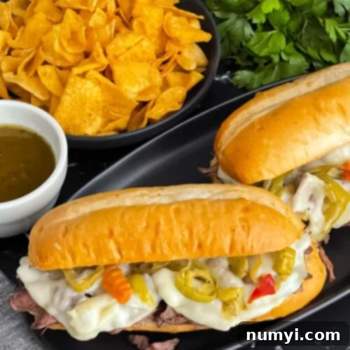Melt-in-Your-Mouth Slow Cooker Italian Beef Sandwiches 11 Italian beef sandwiches on a dark plate.