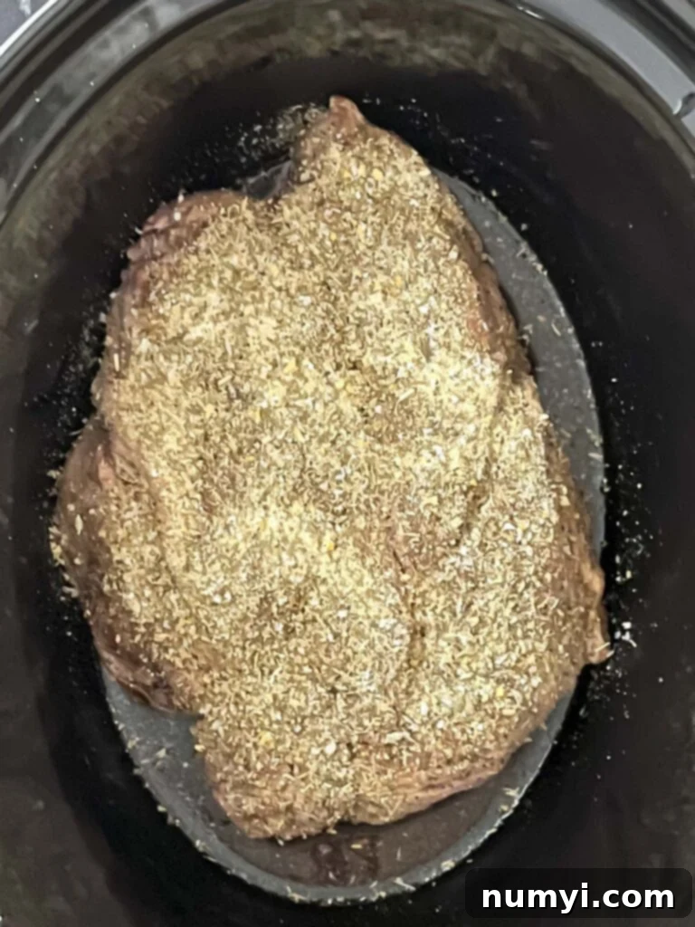 Melt-in-Your-Mouth Slow Cooker Italian Beef Sandwiches 6 Chuck roast in the slow cooker, sprinkled with a homemade seasoning blend.