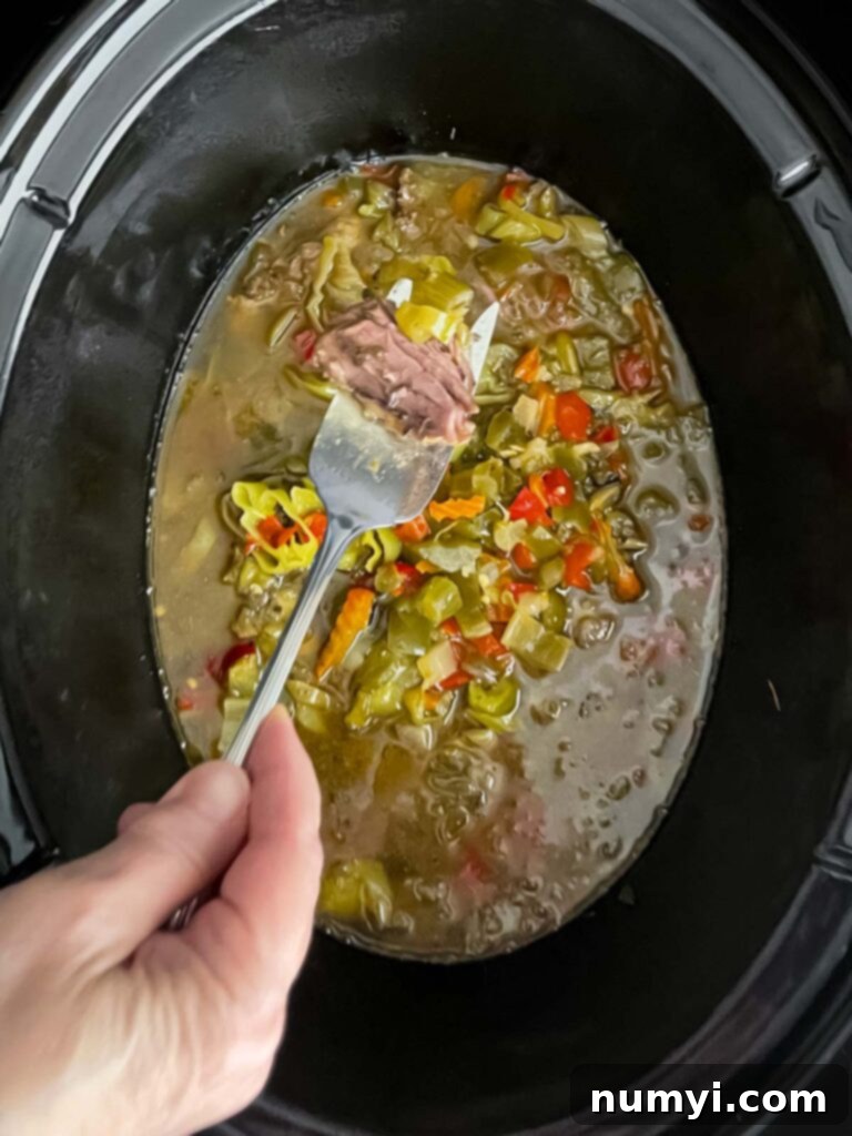 Melt-in-Your-Mouth Slow Cooker Italian Beef Sandwiches 8 Cooked Italian beef simmering in its rich juices in the slow cooker.