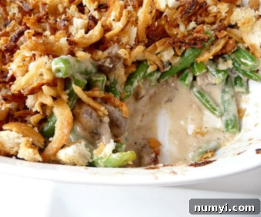 A delicious Fresh Green Bean Casserole, a classic Thanksgiving side dish made with fresh ingredients for enhanced flavor and texture, topped with crispy onions.