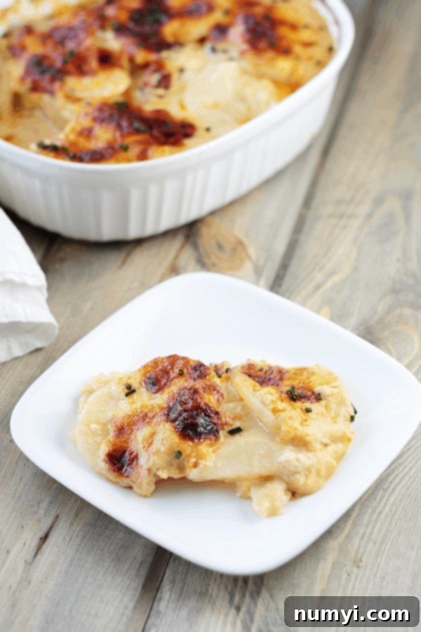 Classic Scalloped Potatoes, thinly sliced potatoes baked in a rich and creamy sauce until tender and golden, a quintessential comfort food for any Thanksgiving dinner.