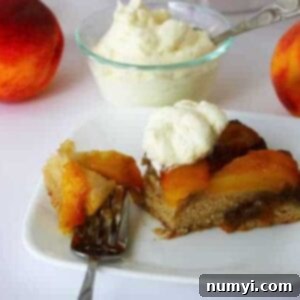 A beautiful, golden-brown peach upside-down cake, inverted to show the caramelized peach topping, ready to be served.