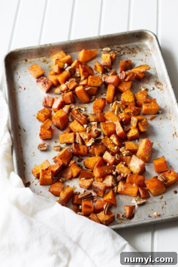 Maple Roasted Sweet Potatoes - these are lightly sweetened with maple syrup, spiced with cinnamon and have an optional crunch from pecans, YUM! | countrysidecravings.com