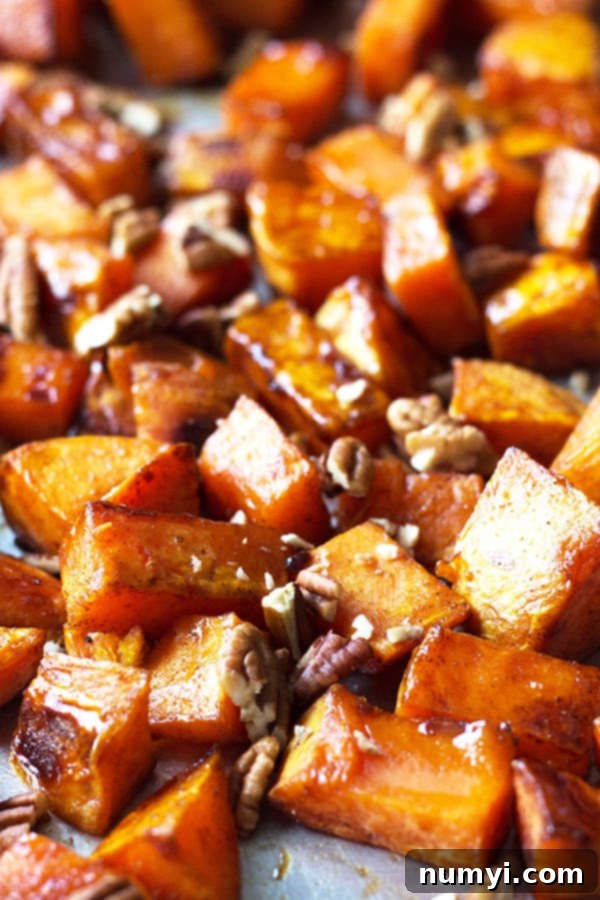 Maple Roasted Sweet Potatoes - these are lightly sweetened with maple syrup, spiced with cinnamon and have an optional crunch from pecans, YUM! | countrysidecravings.com