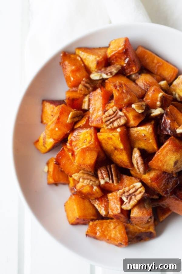 Maple Roasted Sweet Potatoes - these are lightly sweetened with maple syrup, spiced with cinnamon and have an optional crunch from pecans, YUM! | countrysidecravings.com