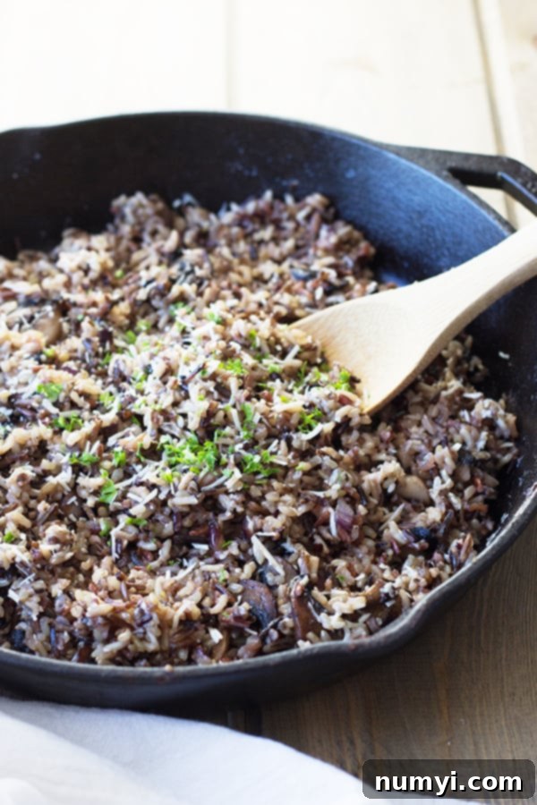 Cheesy Wild Rice with Mushrooms - a rich and flavorful fall side dish featuring Parmesan cheese, wild rice cooked in chicken broth, and perfectly sautéed mushrooms.