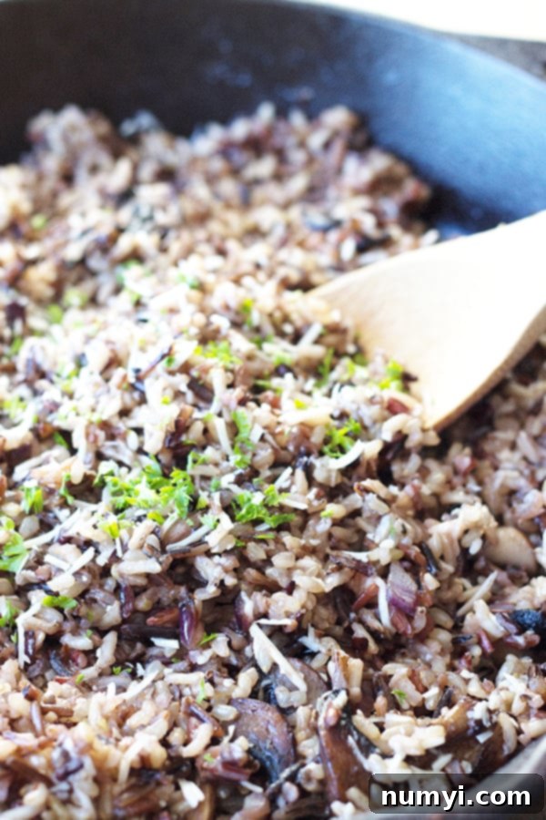Delicious Cheesy Wild Rice with Mushrooms, a rich fall side dish featuring wild rice, Parmesan, and sautéed mushrooms, perfect for any meal.