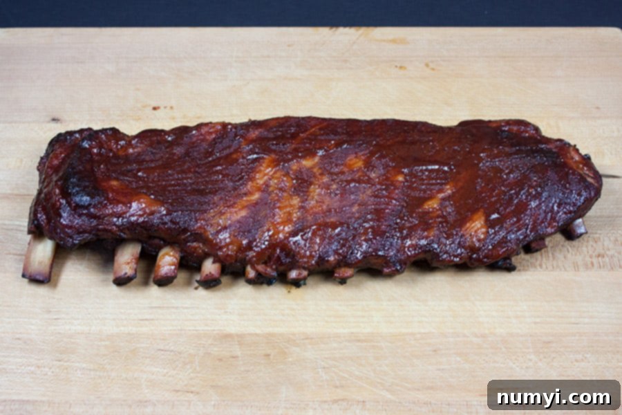 St Louis Style Ribs on a wooden cutting board.