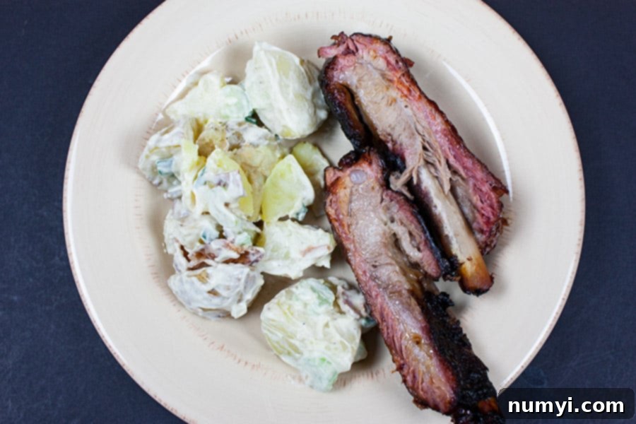 St Louis Style Ribs on a plate with potato salad.