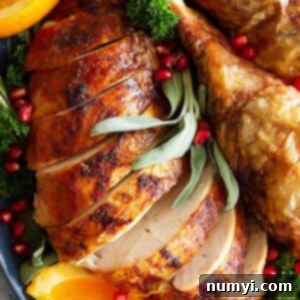 Close-up photo of sliced Beer and Butter Turkey breast on a platter, showcasing its perfect texture and appealing golden color.