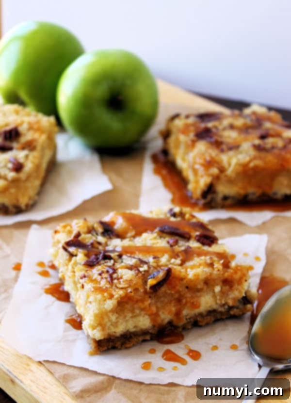 Closeup of perfectly sliced Caramel Apple Cheesecake Bars on a serving platter