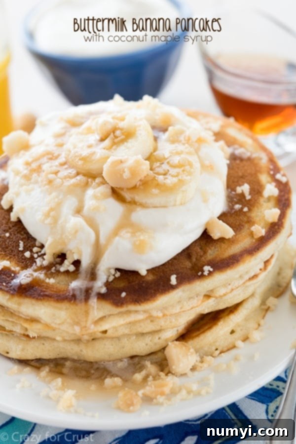 Fluffy Buttermilk Banana Pancakes with Coconut Maple Syrup, a tropical twist on a breakfast classic.