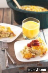 Overnight Slow Cooker Sausage and Potato Bake 5 A top-down view of the uncooked slow cooker potato and sausage breakfast casserole ingredients layered in the crockpot, ready for cooking.
