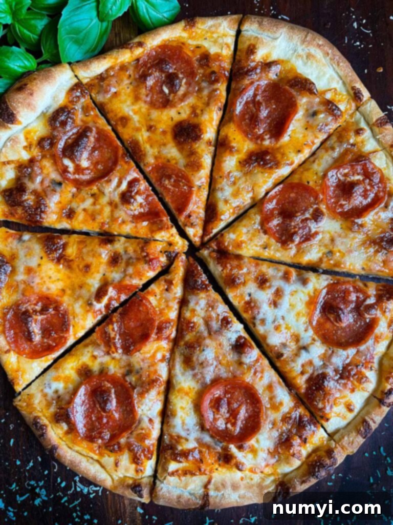 A homemade pepperoni pizza just out of the oven, expertly sliced.