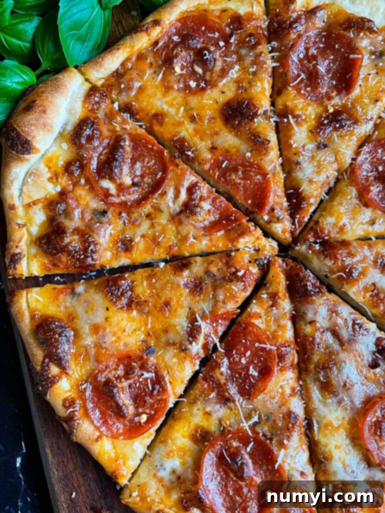 Close-up of a homemade pepperoni pizza slice, showcasing the perfect crust.
