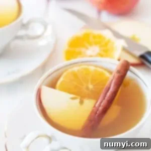 Slow Cooker Apple Cider 5 Slow cooker apple cider in mugs with spices and oranges