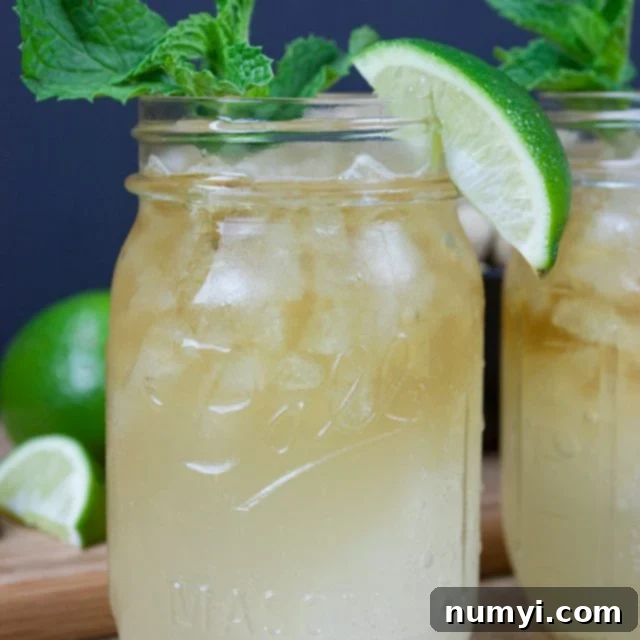 Kentucky Mule served in a large mason jar garnished with fresh mint and a lime wedge.