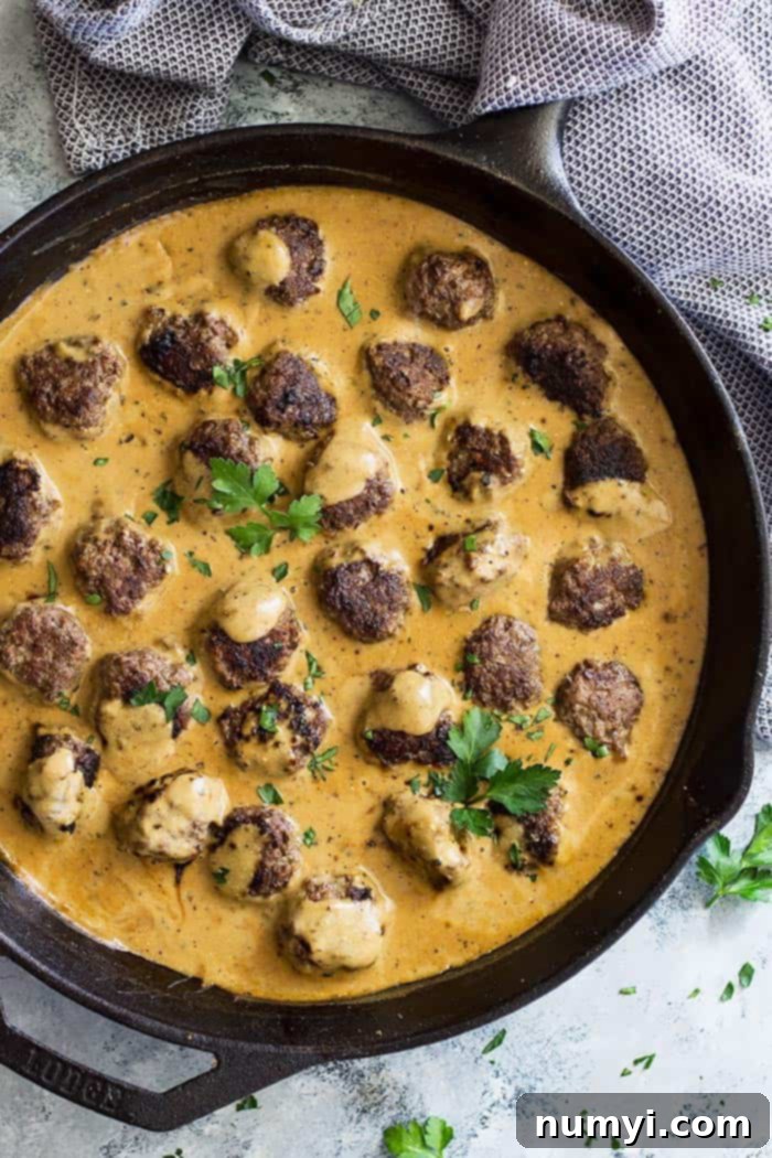 Top down view of Swedish Meatballs in a cast iron skillet. Garnished with parsley. 