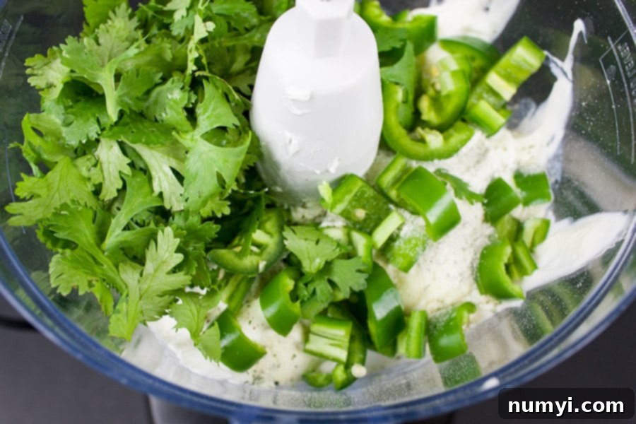 Creamy Jalapeno Cilantro Dip ingredients in the bowl of a food processor