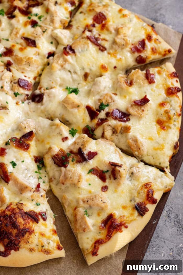 The Ranch Hand's Special 7 Slices of Chicken Bacon Ranch Pizza laid out on a cutting board, garnished with fresh parsley, ready for serving.
