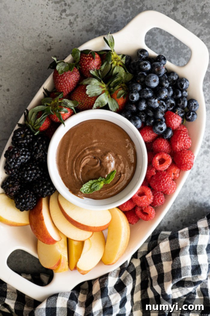 Rich Chocolate Cream Cheese Fruit Dip 2 Overhead view of fruit dip on a platter with fresh fruit all around.