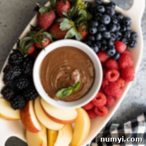 Rich Chocolate Cream Cheese Fruit Dip 7 Overhead view of fruit dip on a platter with fresh fruit all around.