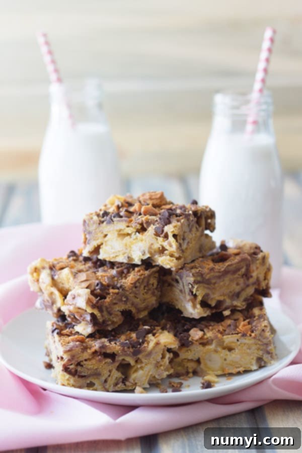 a stack of frito bars on a white plate in front of two glasses of milk