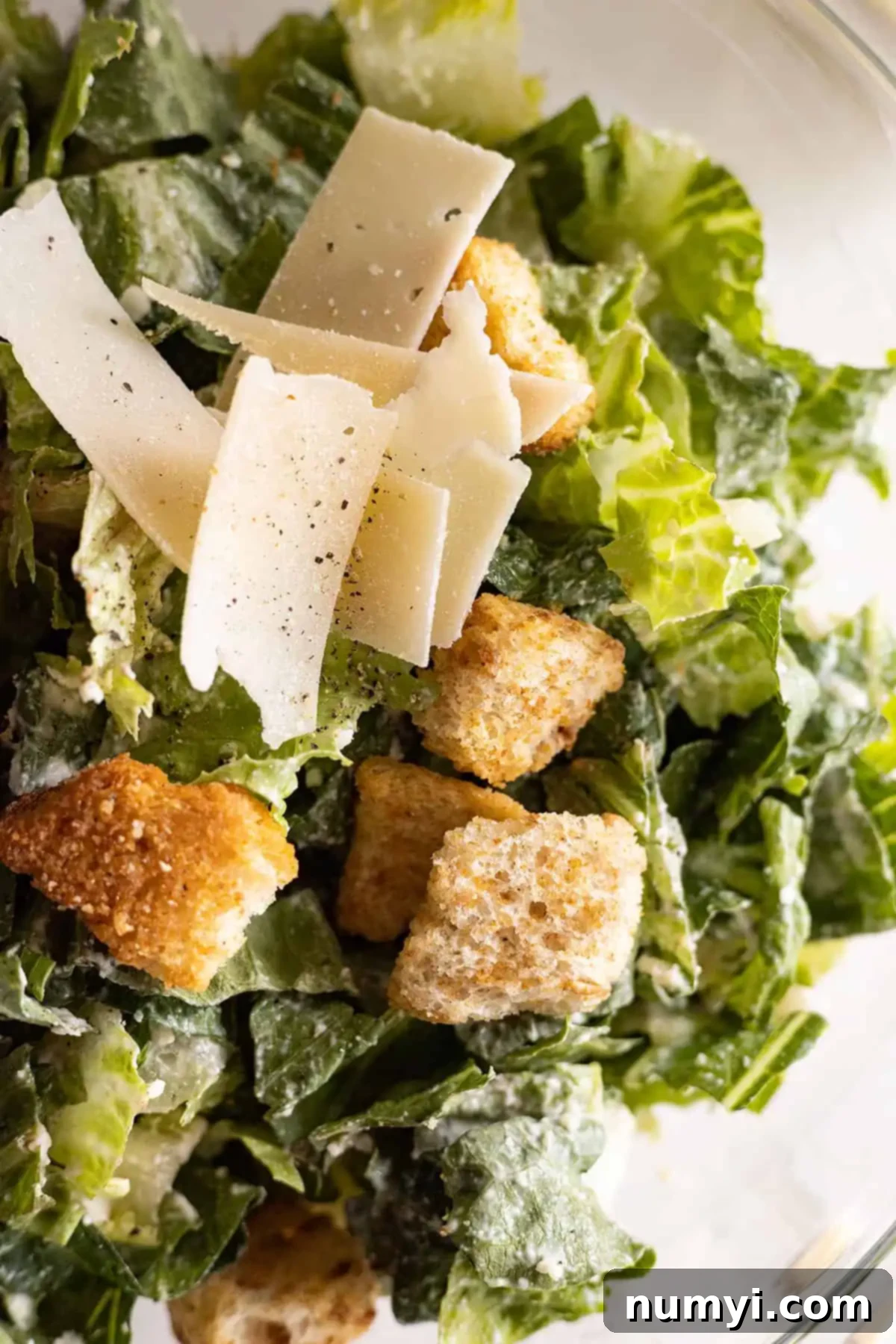 Close up of Easy Caesar Salad with croutons and parmesan. 