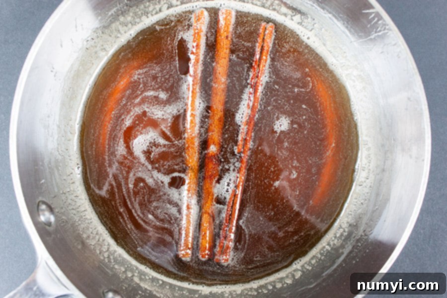 Frosted Cinnamon Macchiato 3 Iced Cinnamon Macchiato - cinnamon simple syrup in a metal saucepan