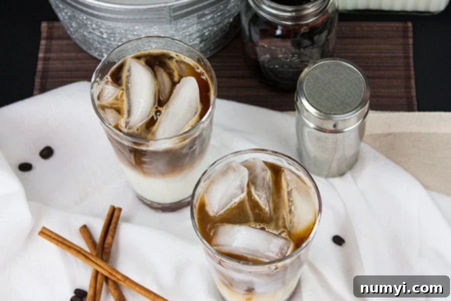 Frosted Cinnamon Macchiato 5 Iced Cinnamon Macchiato on a white cloth with cinnamon sticks garnish