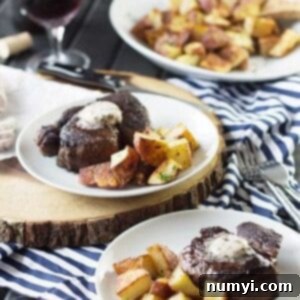 Close-up of a pan-seared filet mignon topped with melting red wine compound butter.