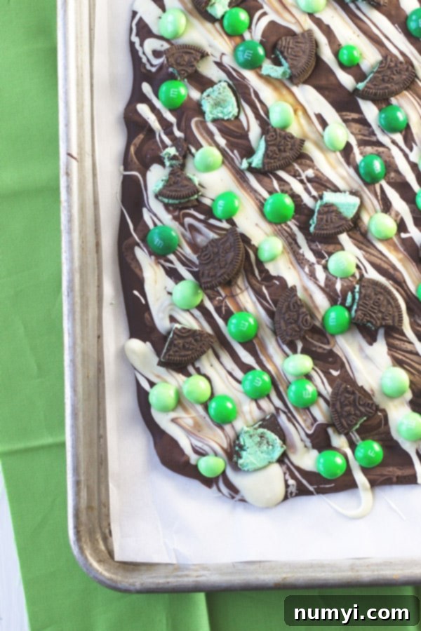 Irresistible St. Patrick's Day Bark with melted chocolate and toppings - an easy, kid-friendly mint chocolate recipe for a festive holiday treat.