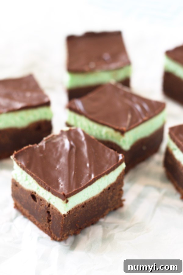 Mint brownies featuring a brownie layer, a mint layer, and a chocolate fudge topping. There are 6 brownies shown.